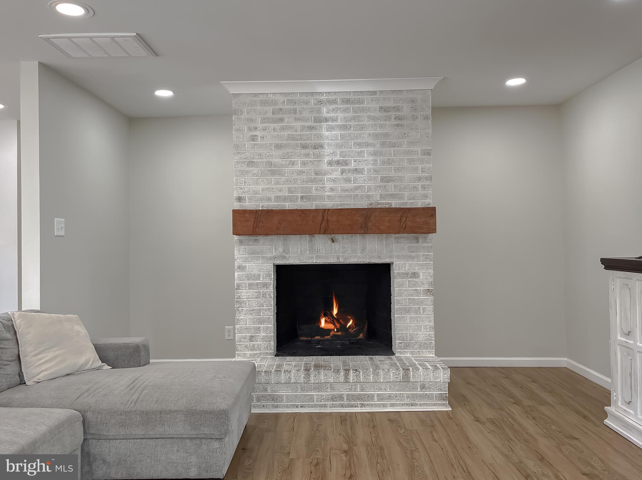 26005 Jones Wharf Road Hollywood, MD 20636 - Photo 17 of 66 a living room with furniture and a fireplace