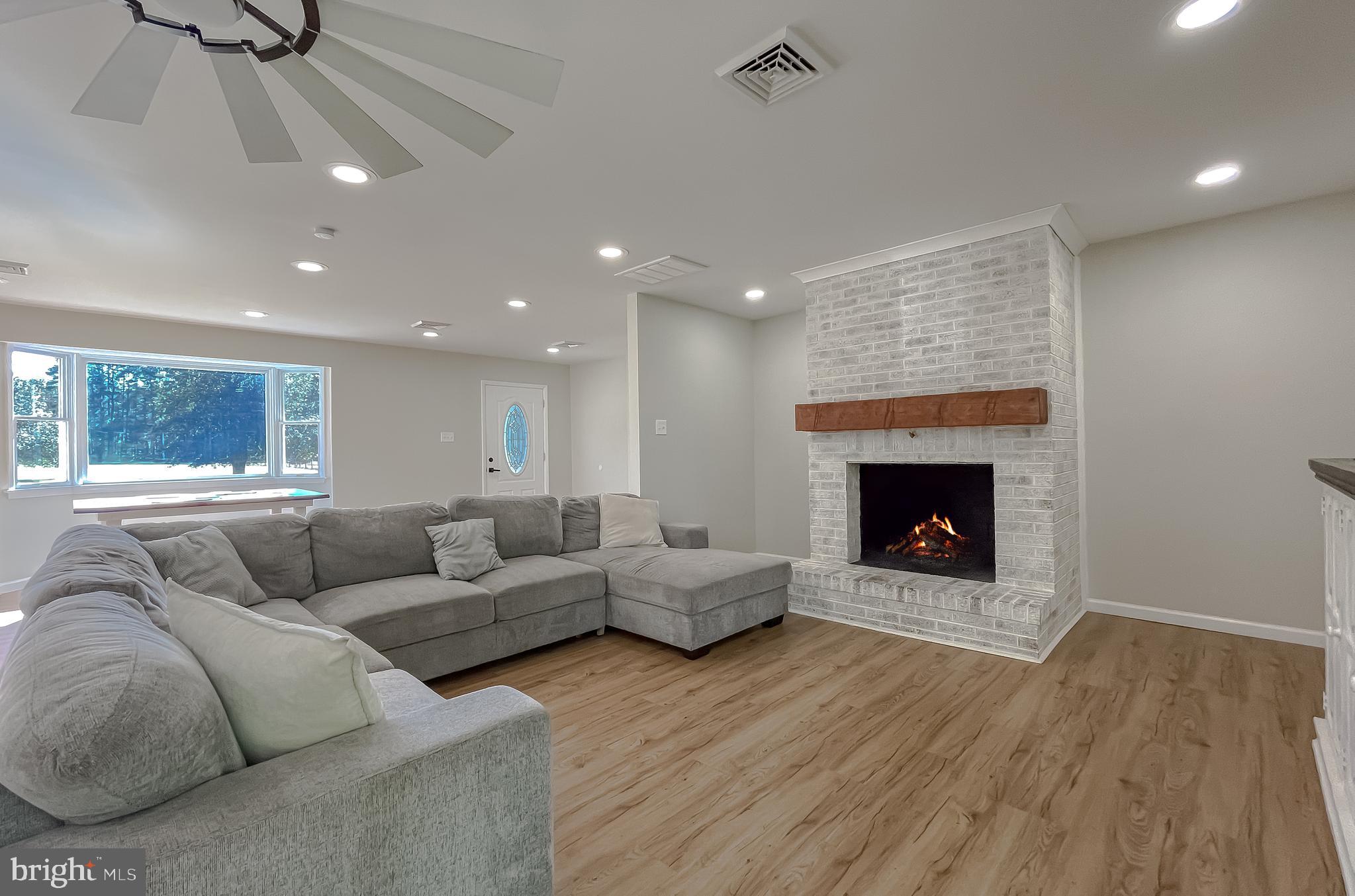 26005 Jones Wharf Road Hollywood, MD 20636 - Photo 19 of 66 a living room with furniture and a fireplace