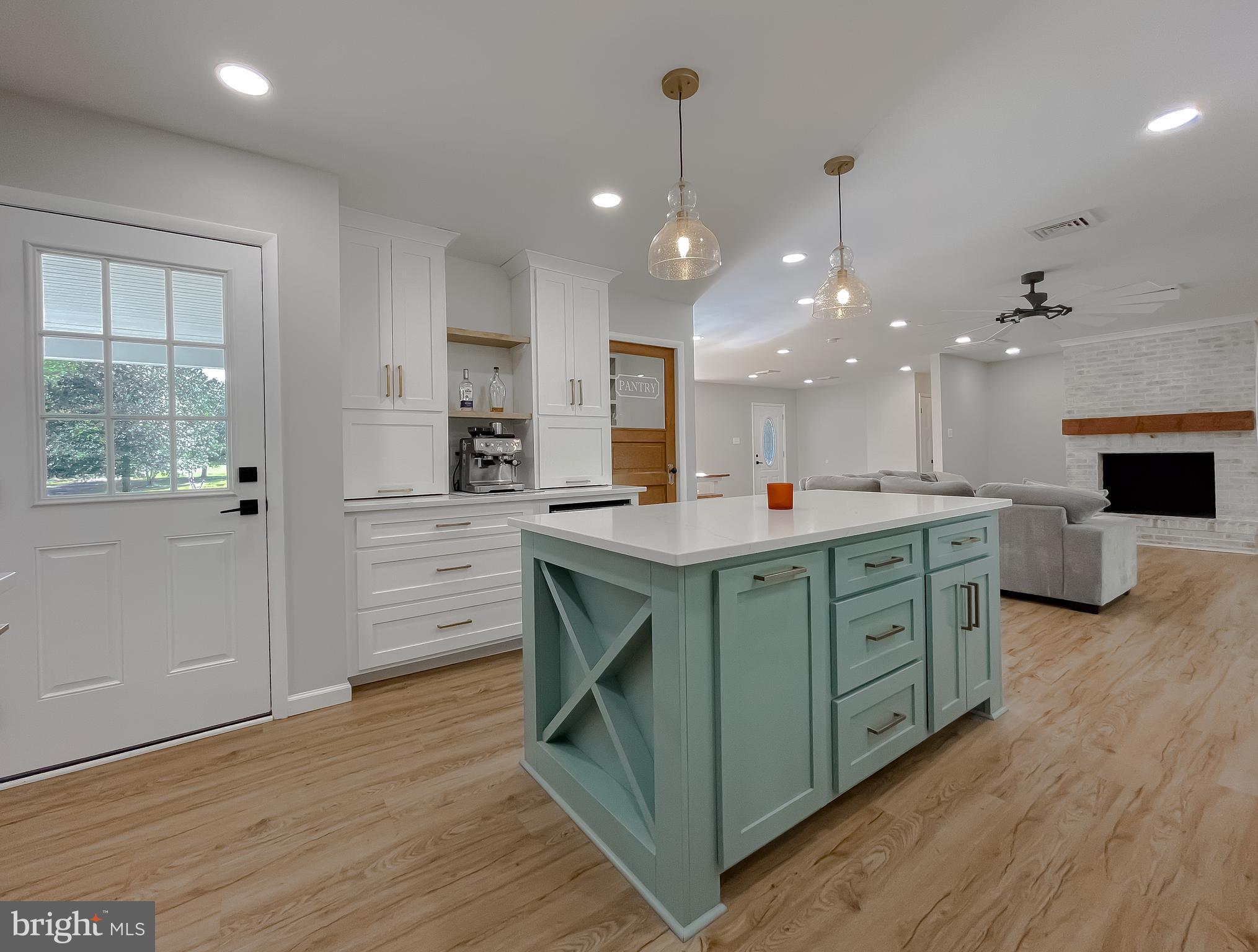 26005 Jones Wharf Road Hollywood, MD 20636 - Photo 24 of 66 a kitchen with kitchen island a sink stainless steel appliances and cabinets