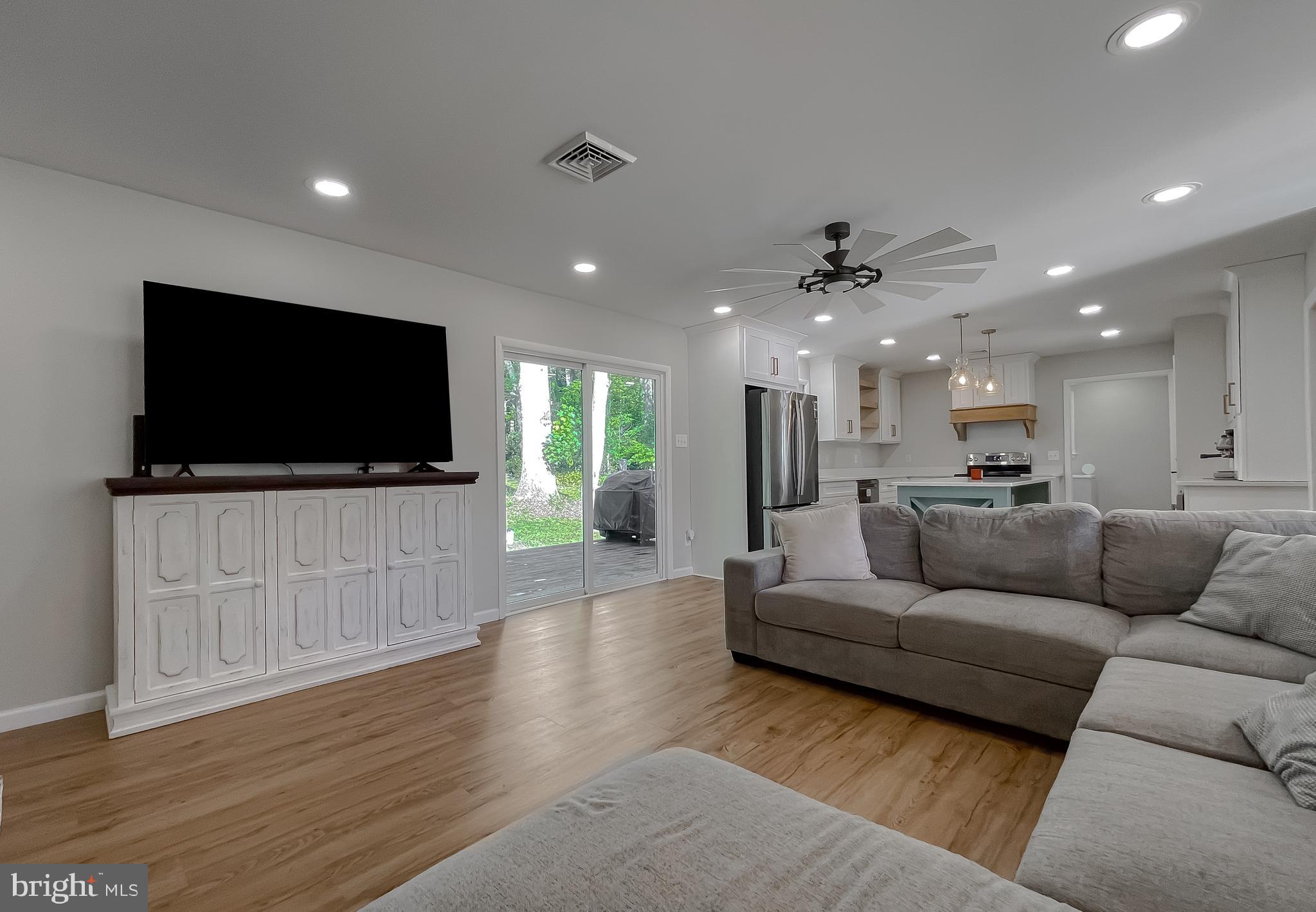 26005 Jones Wharf Road Hollywood, MD 20636 - Photo 32 of 66 a living room with furniture and a flat screen tv