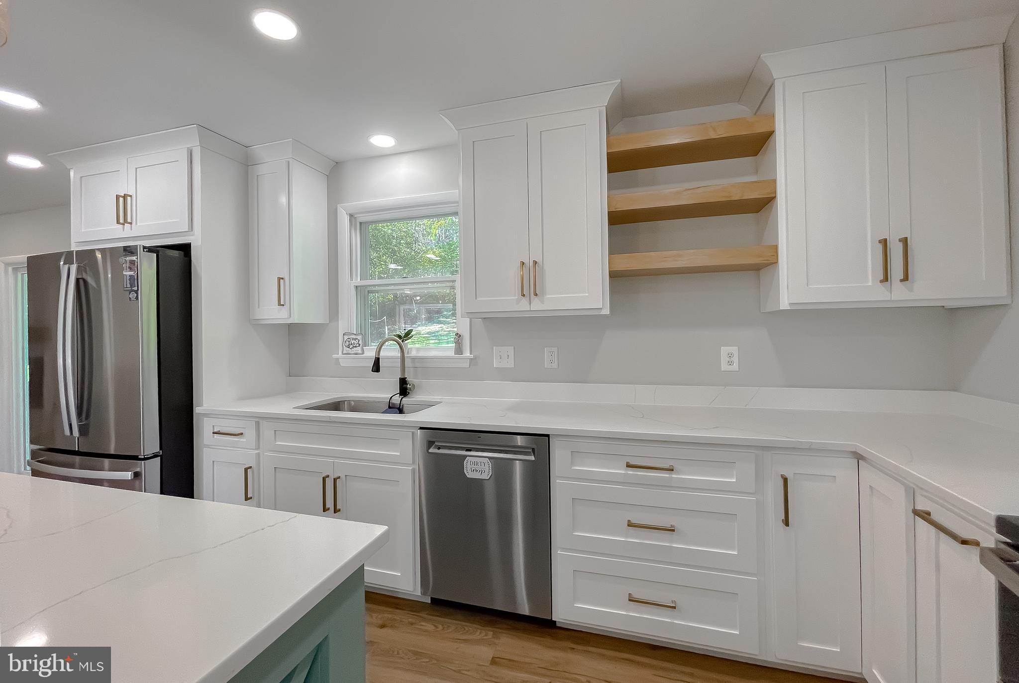 26005 Jones Wharf Road Hollywood, MD 20636 - Photo 35 of 66 a kitchen with stainless steel appliances a refrigerator sink and cabinets