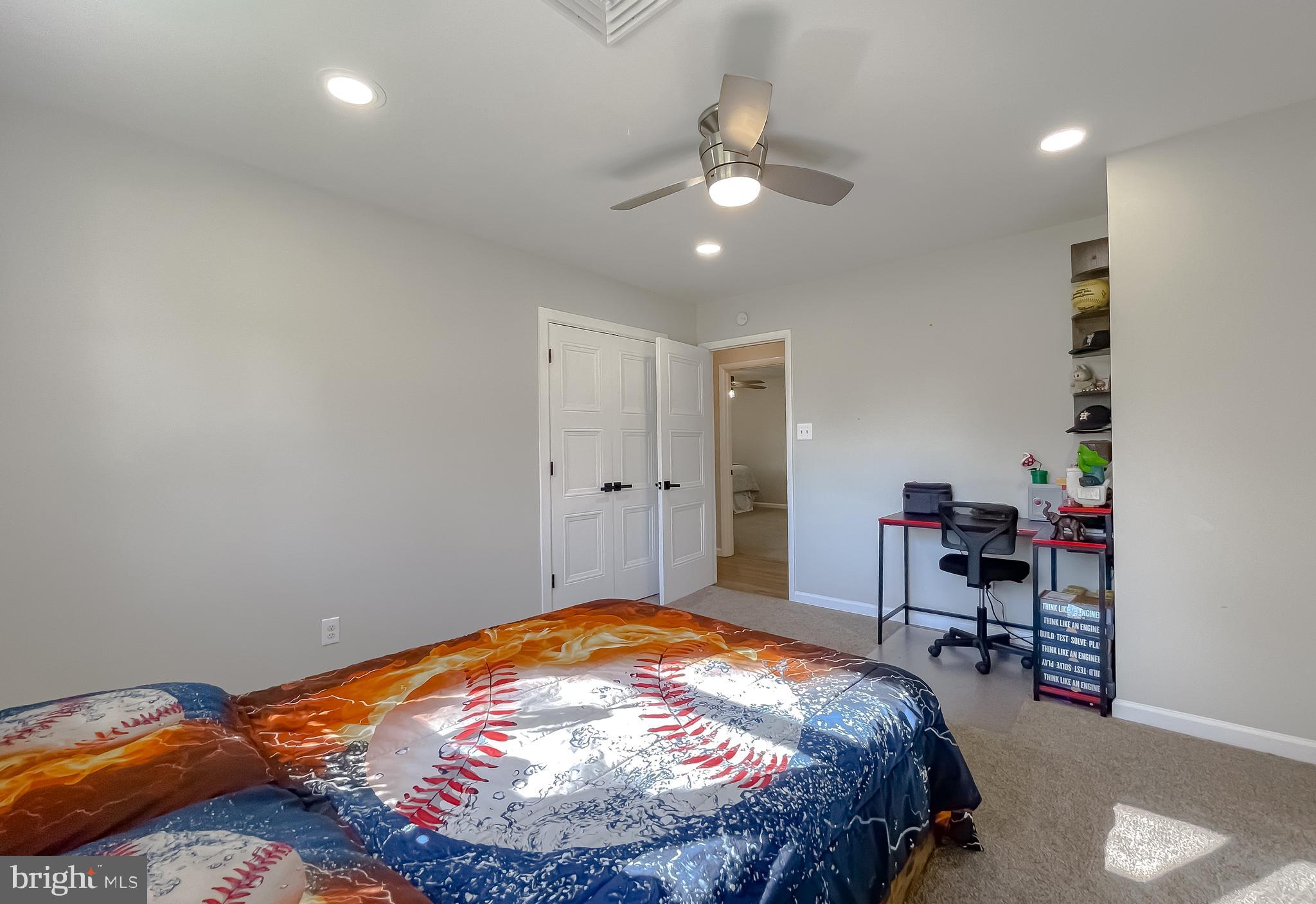 26005 Jones Wharf Road Hollywood, MD 20636 - Photo 43 of 66 a bedroom with a bed and a chandelier