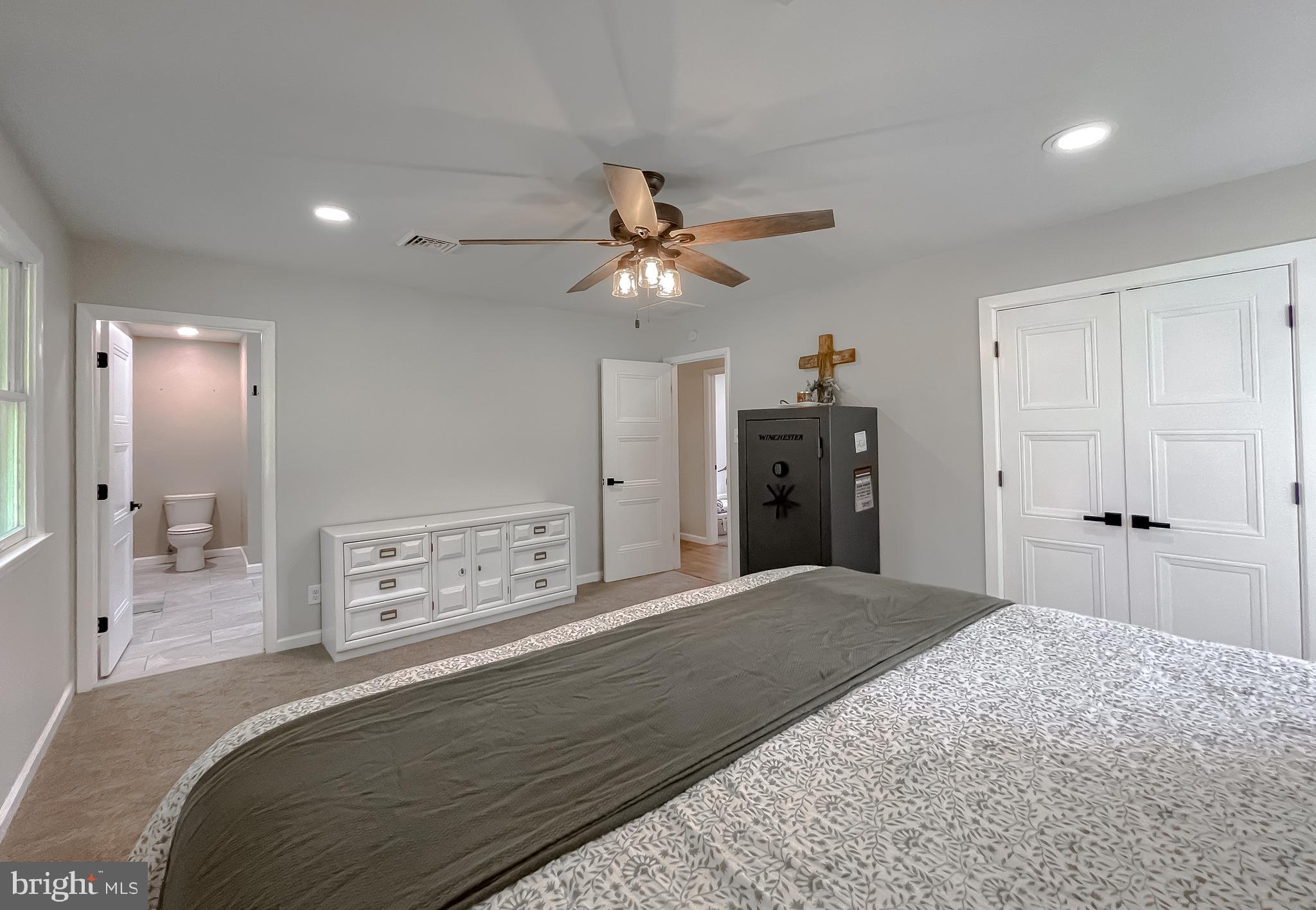 26005 Jones Wharf Road Hollywood, MD 20636 - Photo 50 of 66 a bedroom with a bed and a chandelier