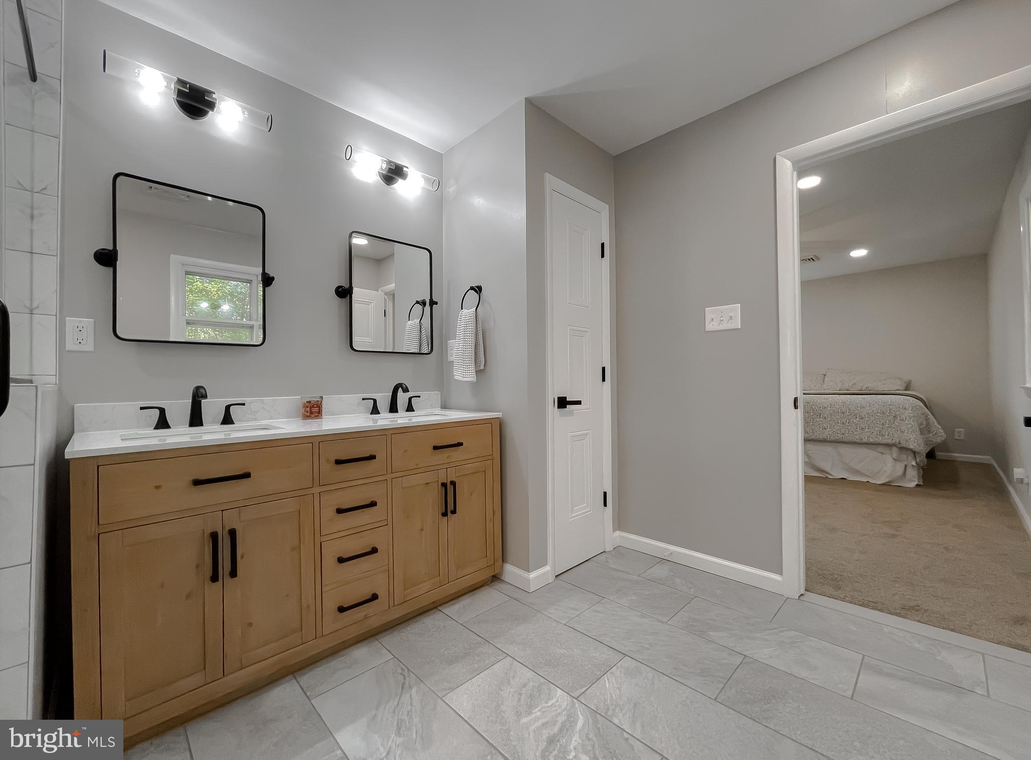 26005 Jones Wharf Road Hollywood, MD 20636 - Photo 54 of 66 a spacious bathroom with a double vanity sink double and mirror