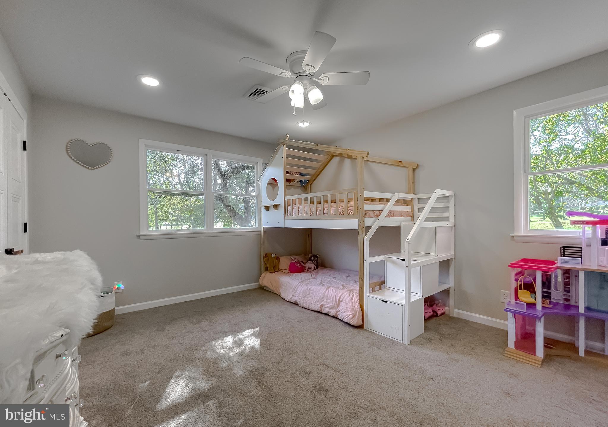 26005 Jones Wharf Road Hollywood, MD 20636 - Photo 55 of 66 a bedroom with furniture and a chandelier