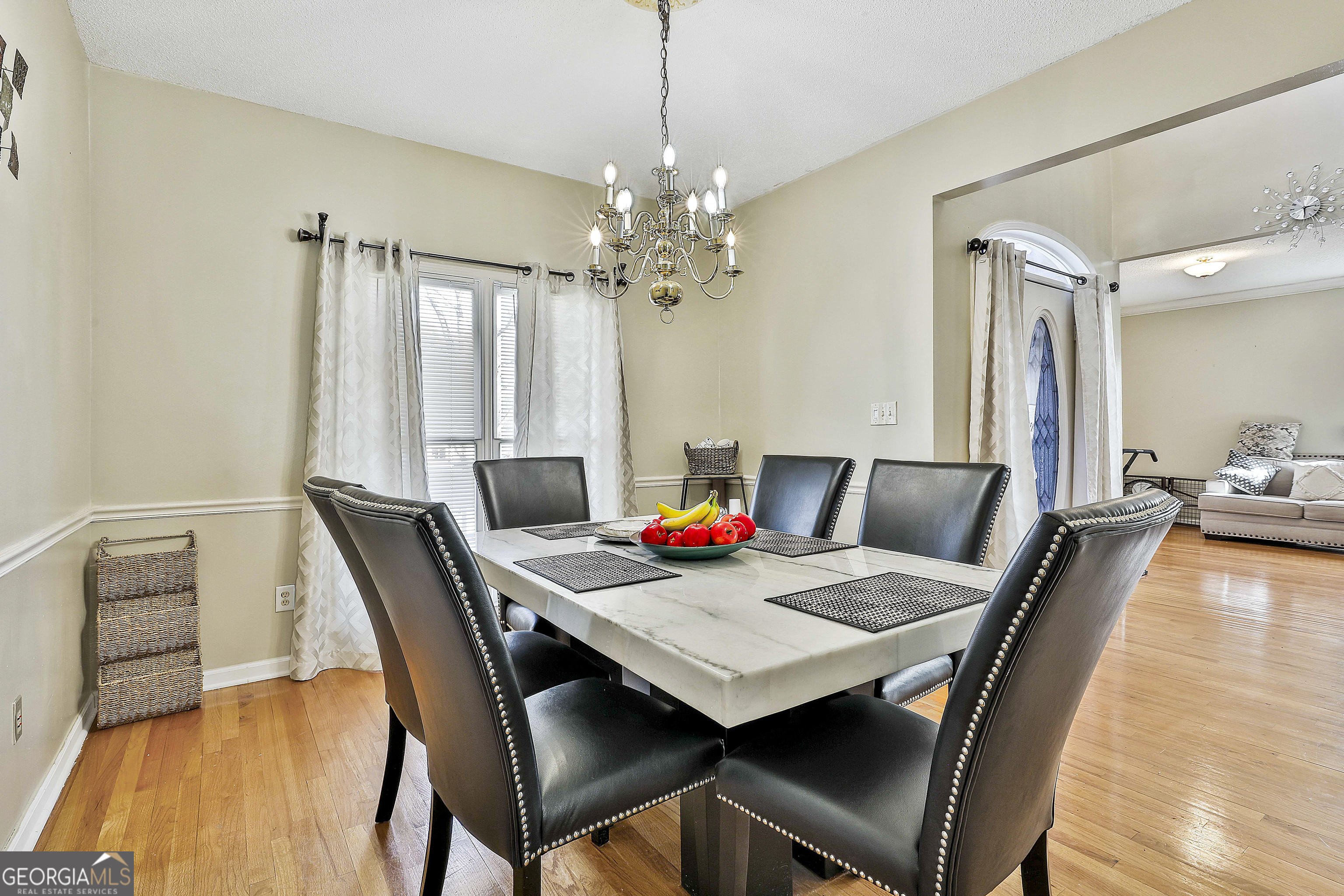 1317 Cheatham Road Griffin, GA 30223 - Photo 11 of 41 a view of a dining room with furniture a chandelier and wooden floor