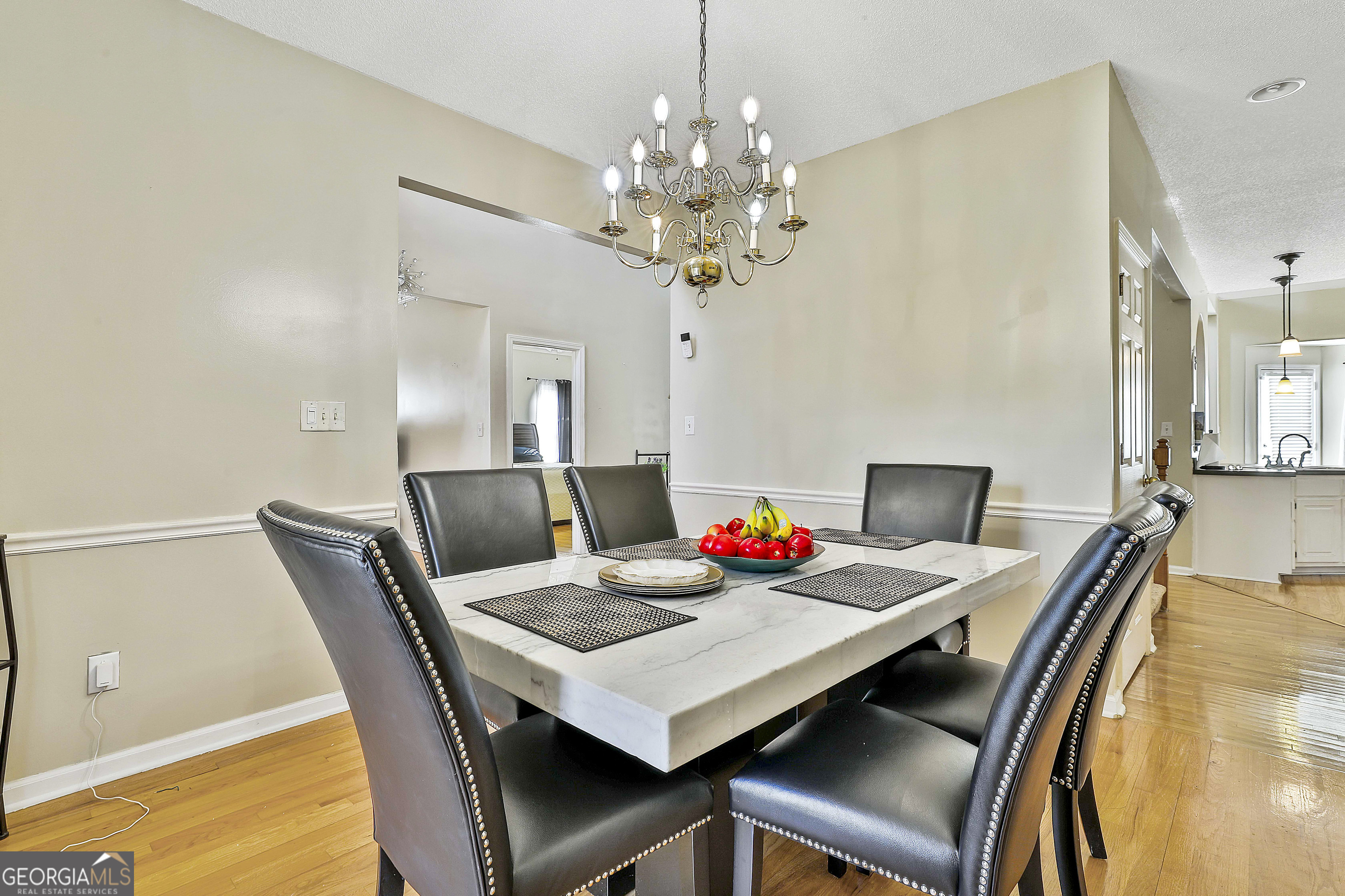 1317 Cheatham Road Griffin, GA 30223 - Photo 12 of 41 a view of a dining room with furniture and chandelier