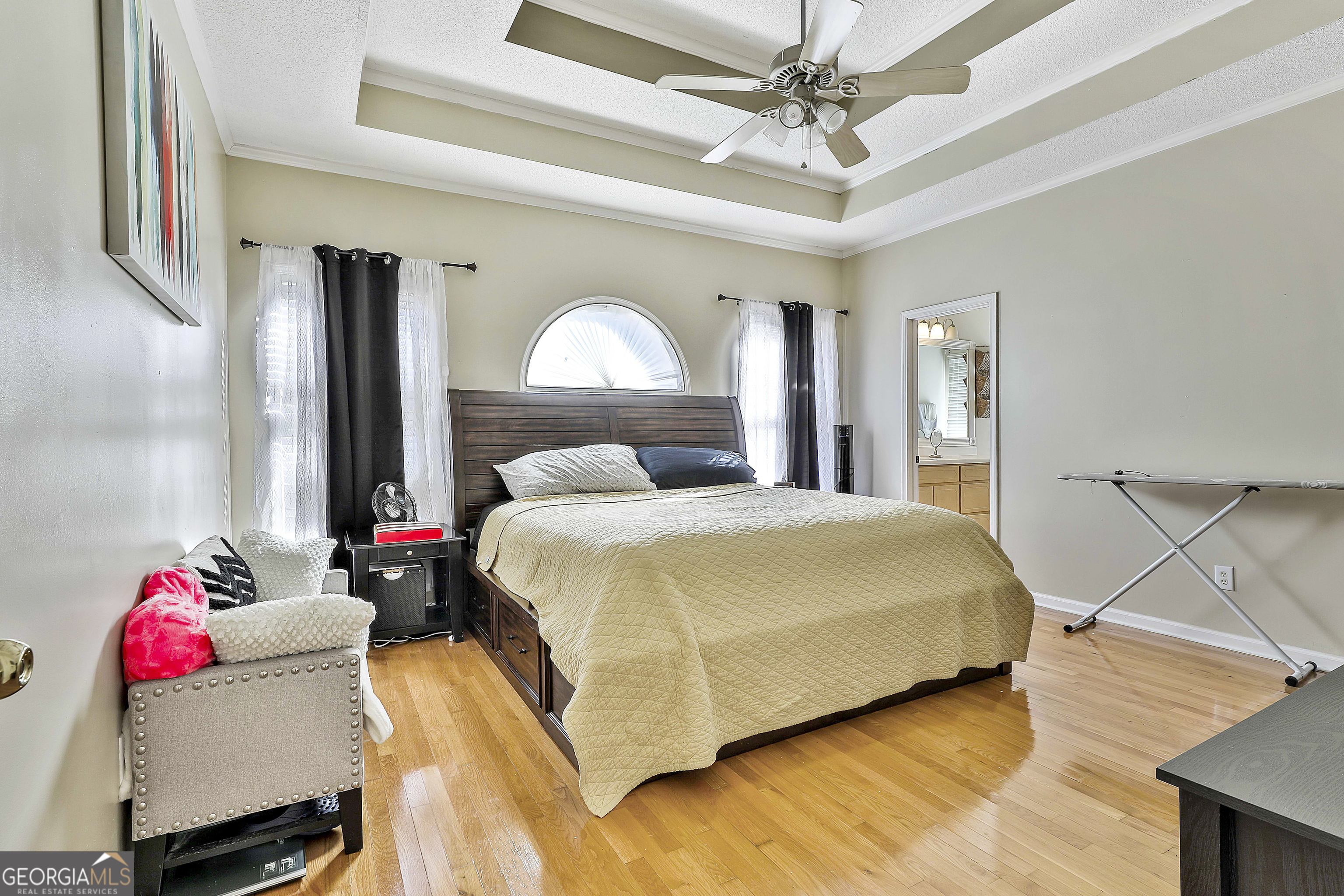 1317 Cheatham Road Griffin, GA 30223 - Photo 16 of 41 a bedroom with a bed and a chandelier