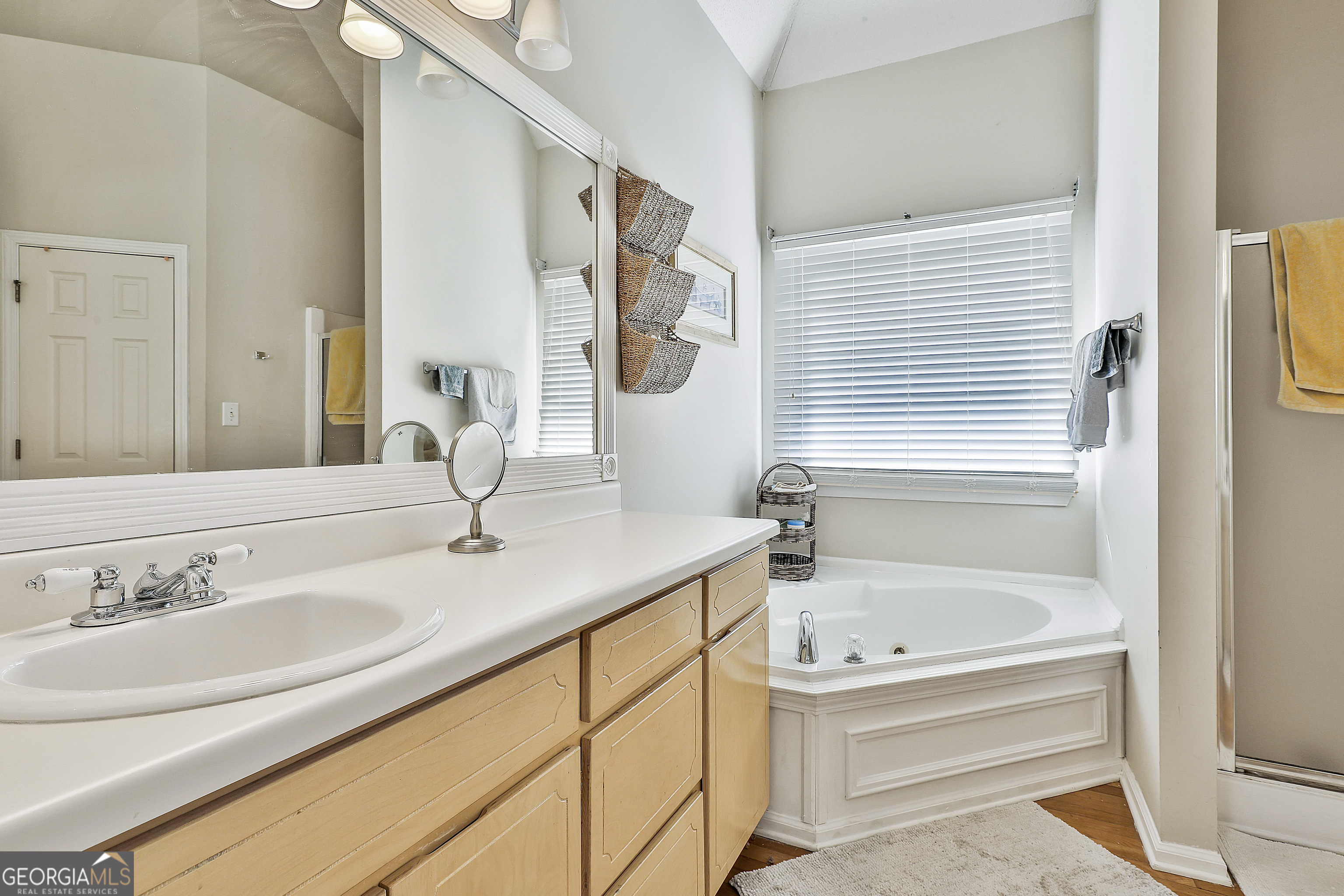 1317 Cheatham Road Griffin, GA 30223 - Photo 18 of 41 a bathroom with a granite countertop sink and a bathtub