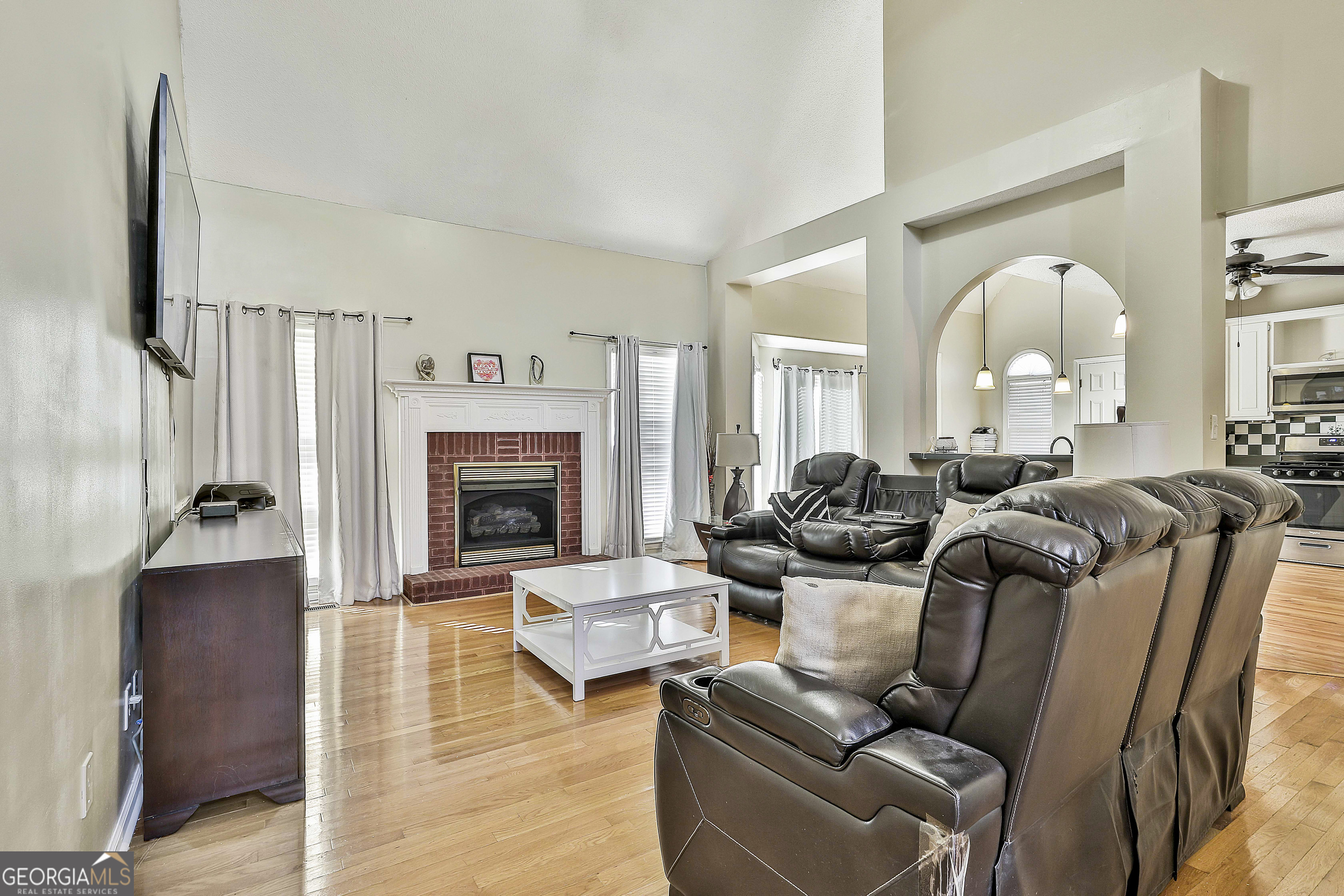 1317 Cheatham Road Griffin, GA 30223 - Photo 20 of 41 a living room with furniture large window and a fireplace