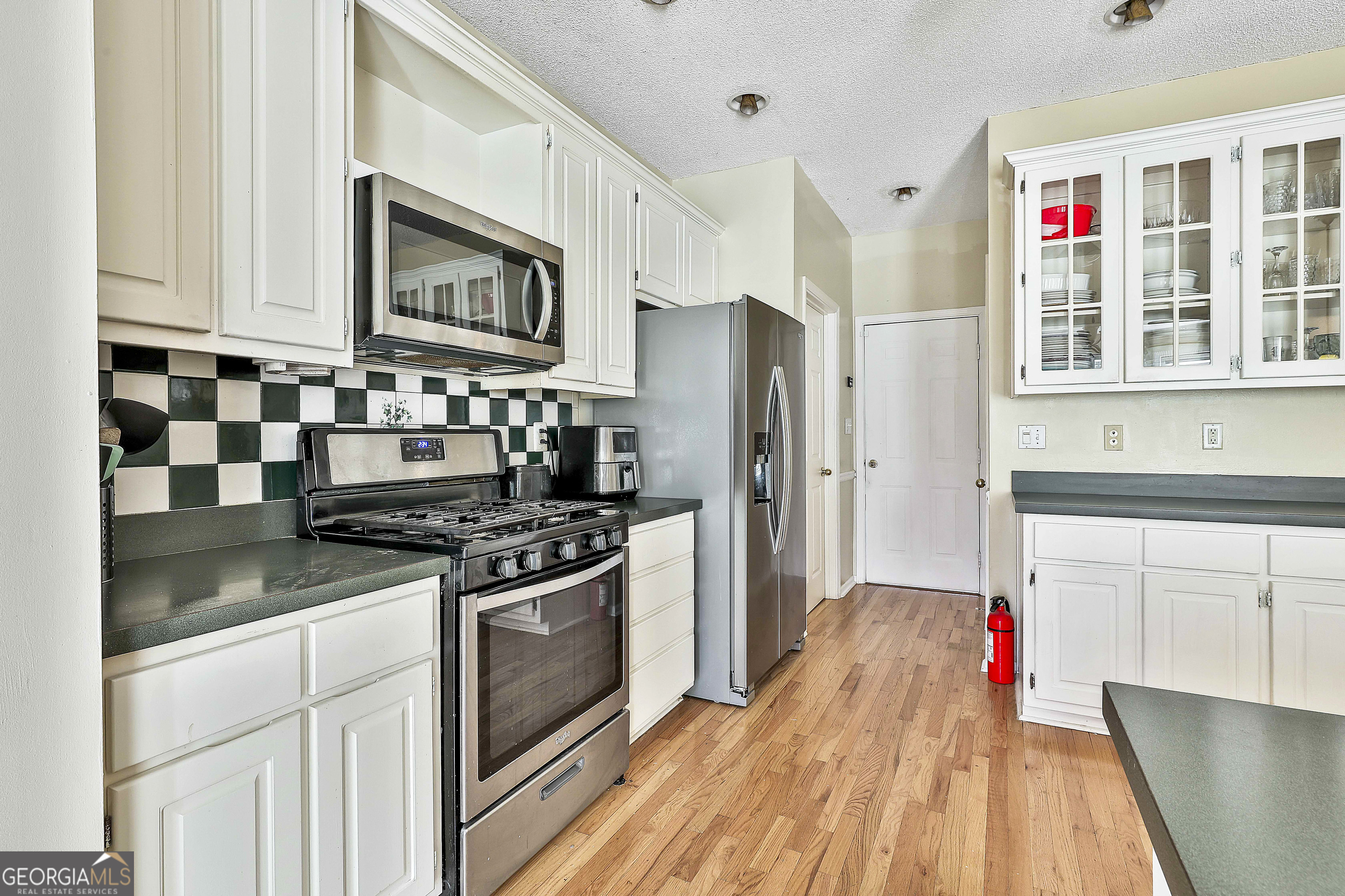 1317 Cheatham Road Griffin, GA 30223 - Photo 27 of 41 a kitchen with stainless steel appliances granite countertop a stove and a refrigerator