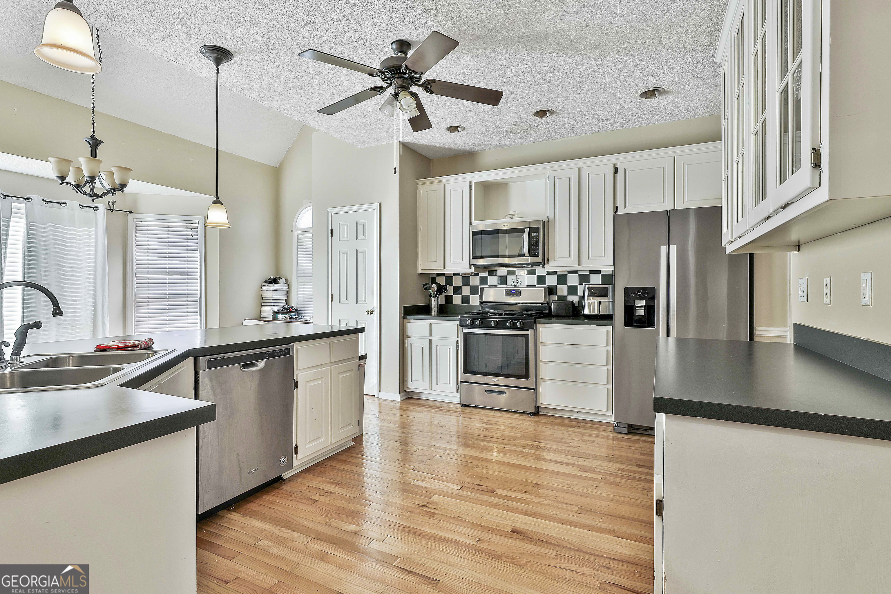 1317 Cheatham Road Griffin, GA 30223 - Photo 30 of 41 a large kitchen with a counter space a sink stainless steel appliances and cabinets