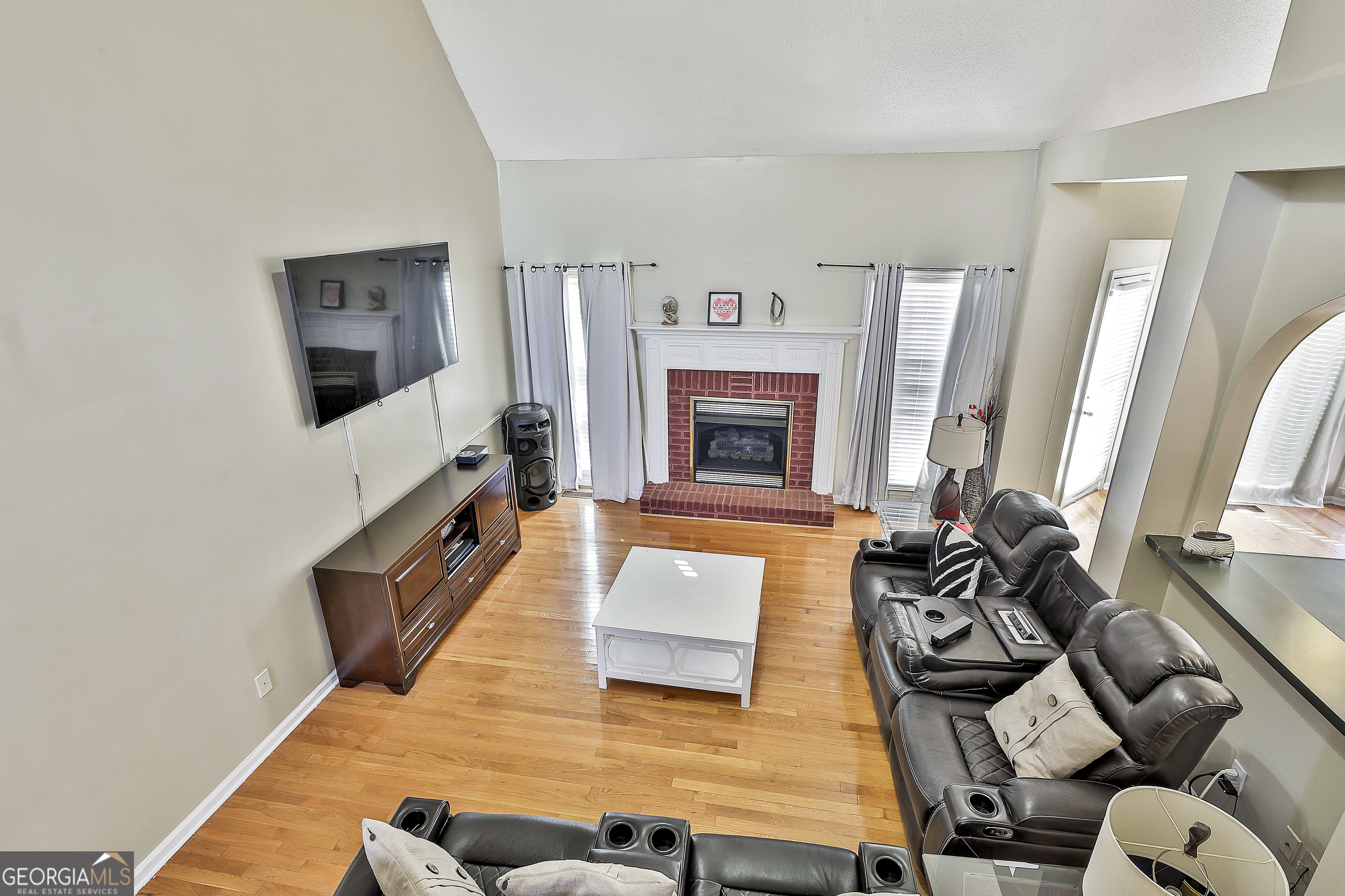 1317 Cheatham Road Griffin, GA 30223 - Photo 31 of 41 a living room with furniture fireplace and flat screen tv