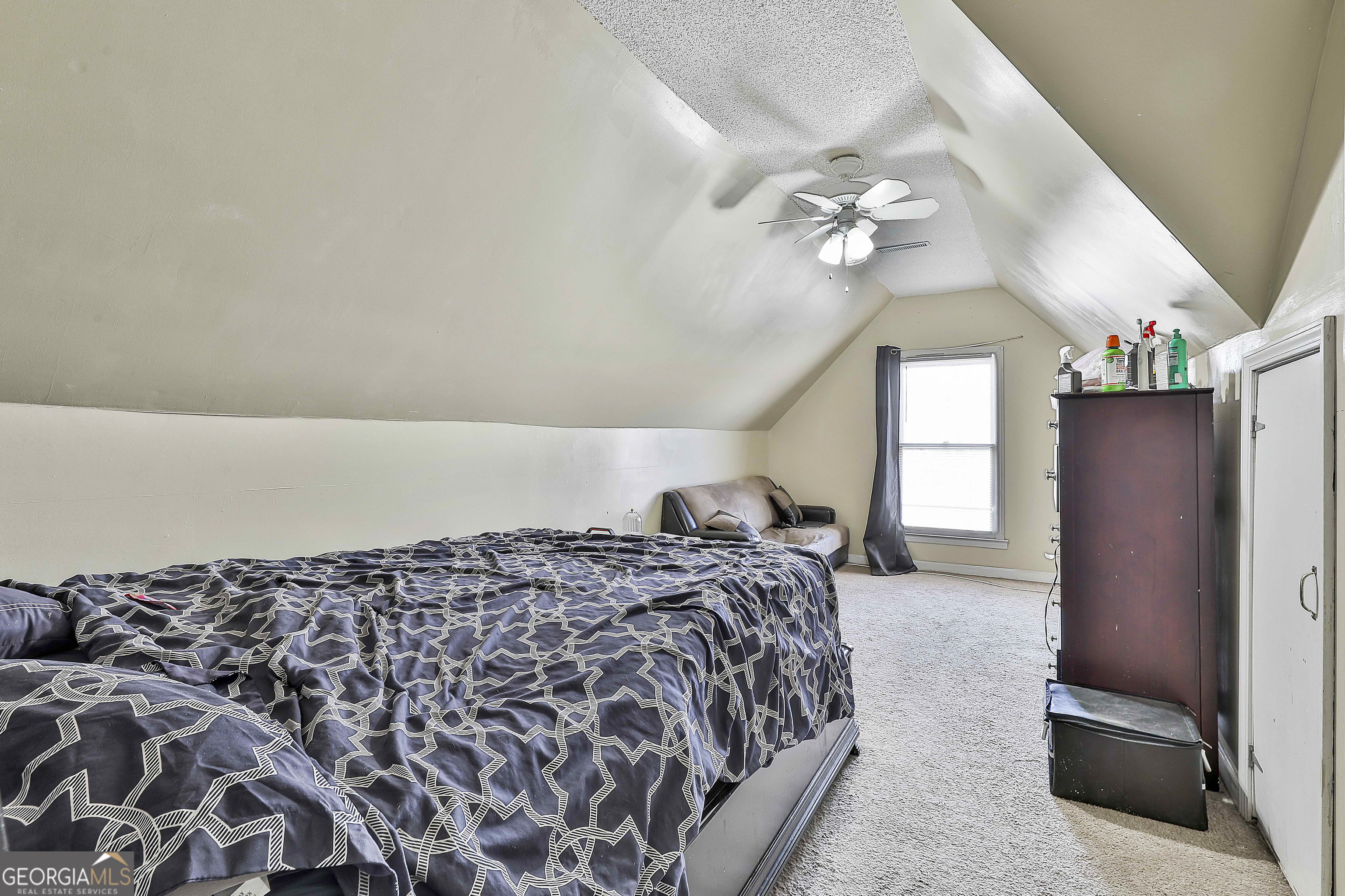 1317 Cheatham Road Griffin, GA 30223 - Photo 35 of 41 a spacious bedroom with a bed dresser and a window