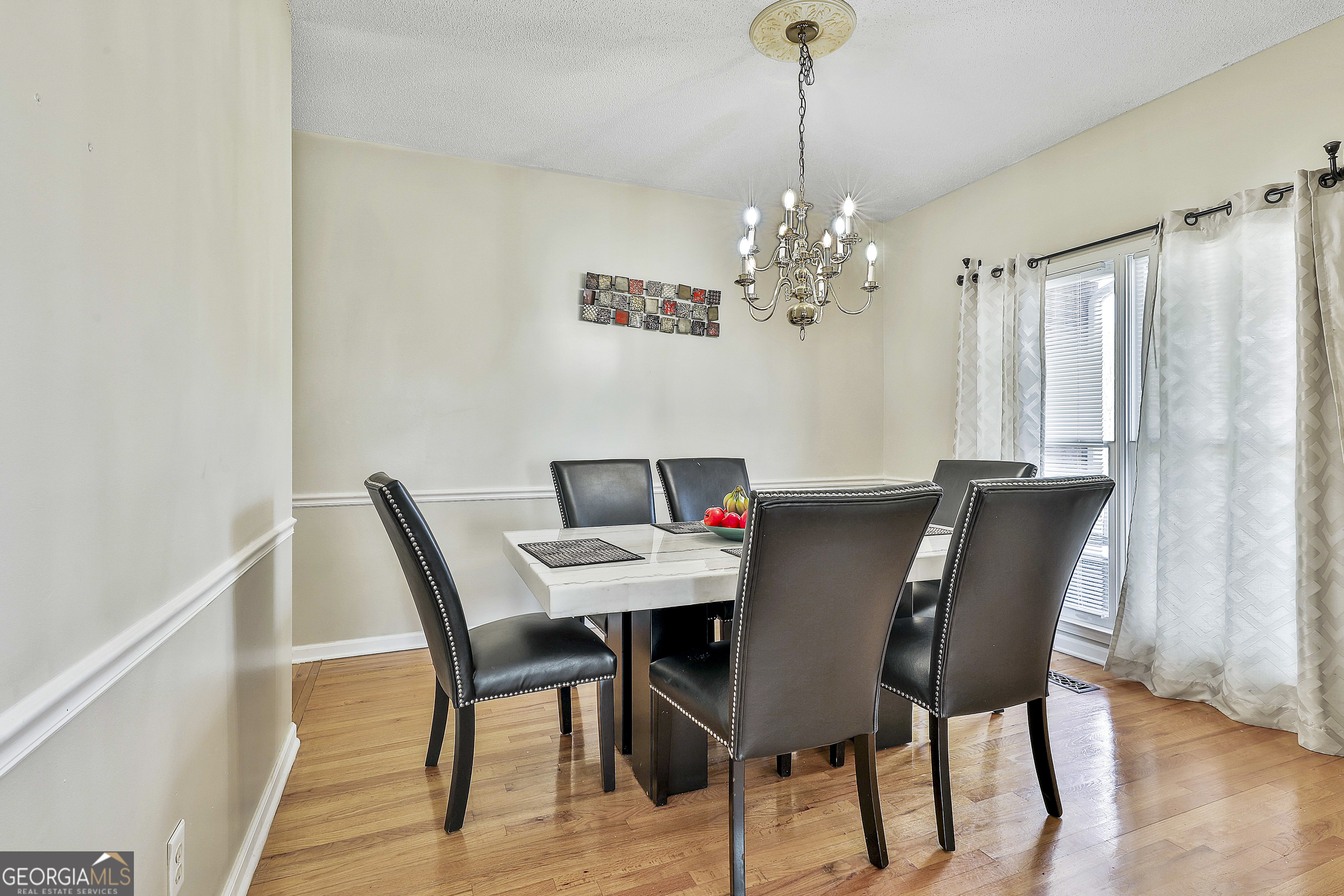1317 Cheatham Road Griffin, GA 30223 - Photo 10 of 41 a view of a dining room with furniture and chandelier