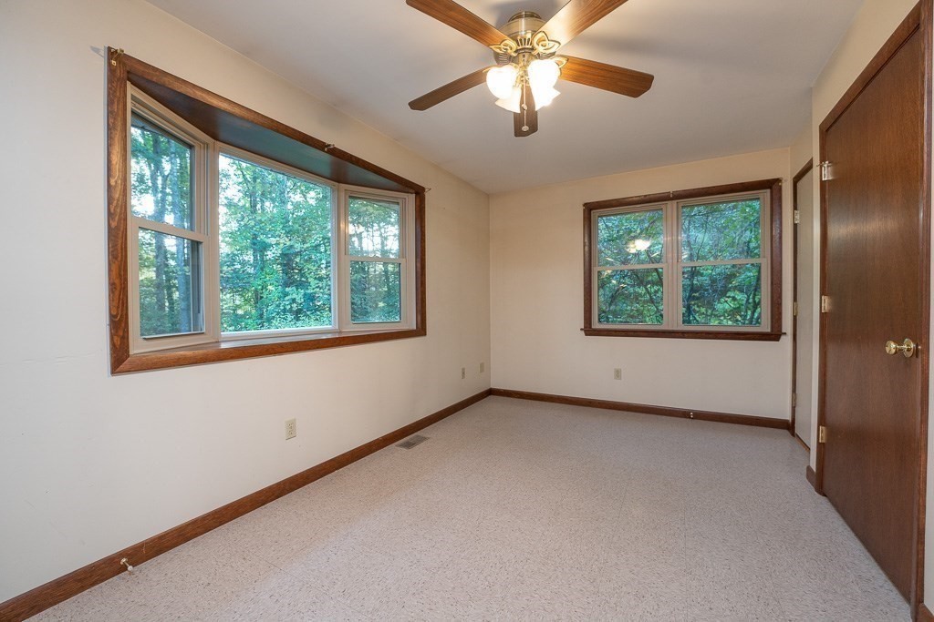 98 Fomer Road Southampton, MA 01073 - Photo 8 of 42 an empty room with windows and chandelier fan