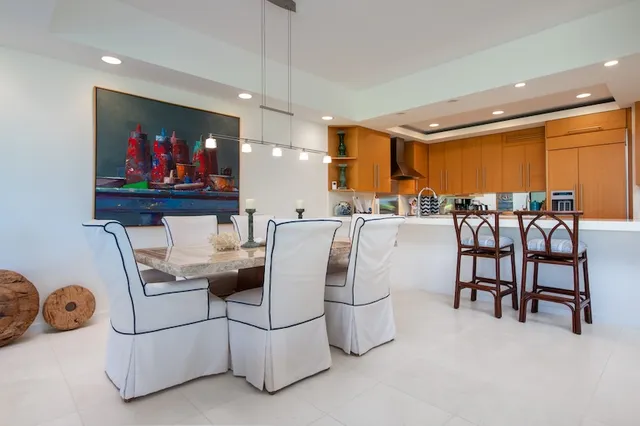 a dining room with furniture and a large window