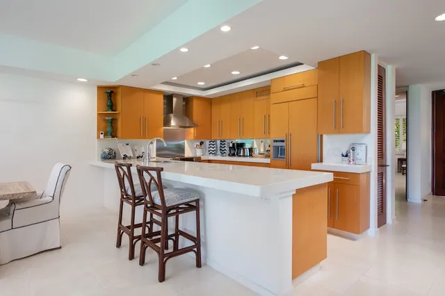 a large kitchen with stainless steel appliances granite countertop a large stove a sink and a refrigerator