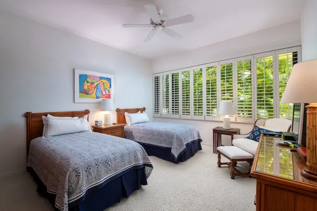 a bathroom with a granite countertop sink toilet and mirror