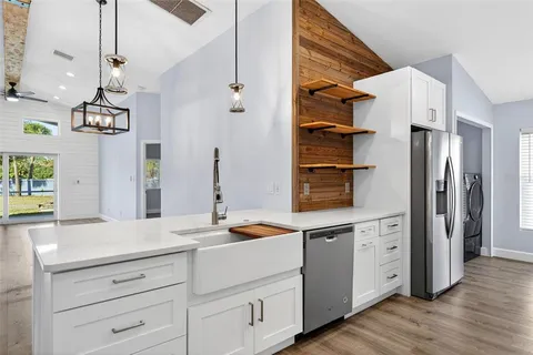 a kitchen with stainless steel appliances a refrigerator sink and cabinets