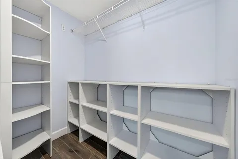 a spacious bathroom with a toilet sink and mirror