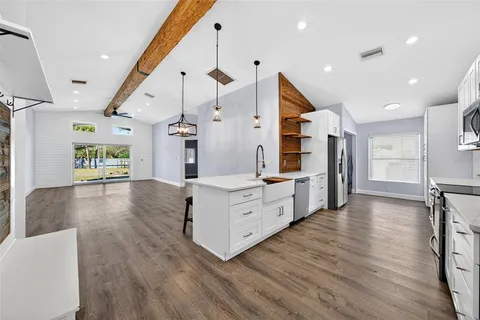 a kitchen with refrigerator cabinets and wooden floor