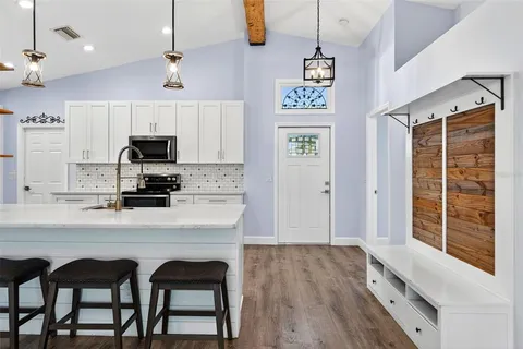 a view of walk in closet with wooden floor