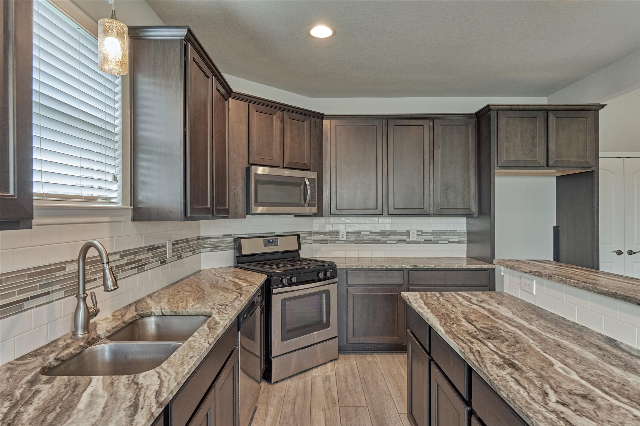 180 Racetrack Lane Montgomery, TX 77356 - Photo 4 of 46 Kitchen opens to family room.