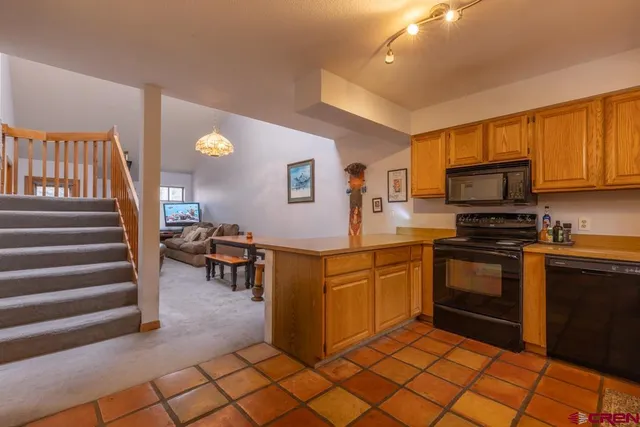 a living room with furniture a couch and a large window