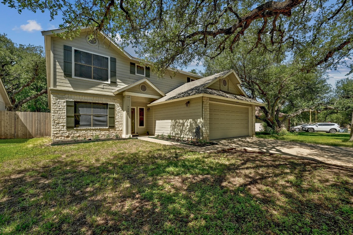 7201 Pine Bluffs Trail Austin, TX 78729 - Photo 2 of 25 a front view of a house with a garden