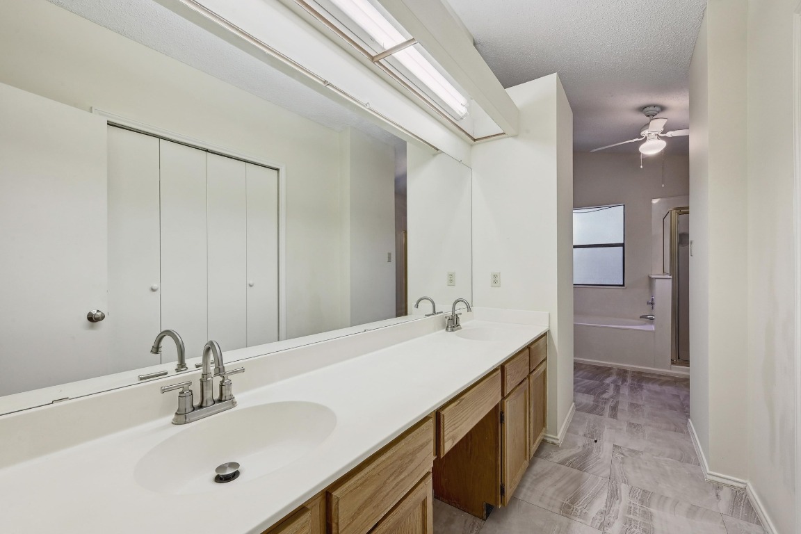 7201 Pine Bluffs Trail Austin, TX 78729 - Photo 21 of 25 a bathroom with a sink and a mirror