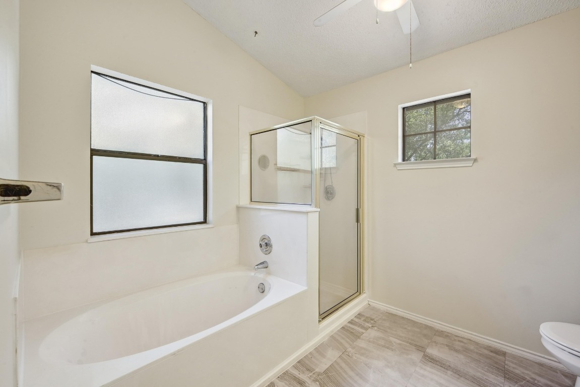 7201 Pine Bluffs Trail Austin, TX 78729 - Photo 22 of 25 a bathroom with a bathtub and shower