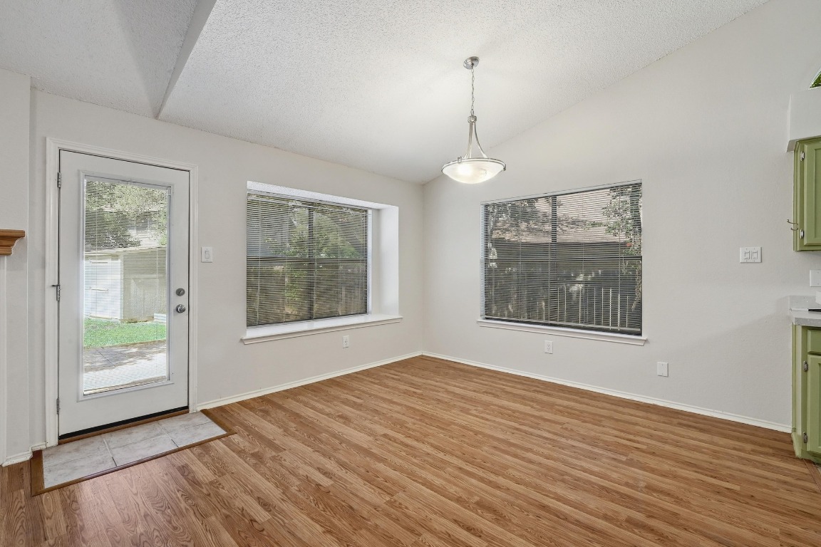 7201 Pine Bluffs Trail Austin, TX 78729 - Photo 6 of 25 a view of an empty room with window and wooden floor