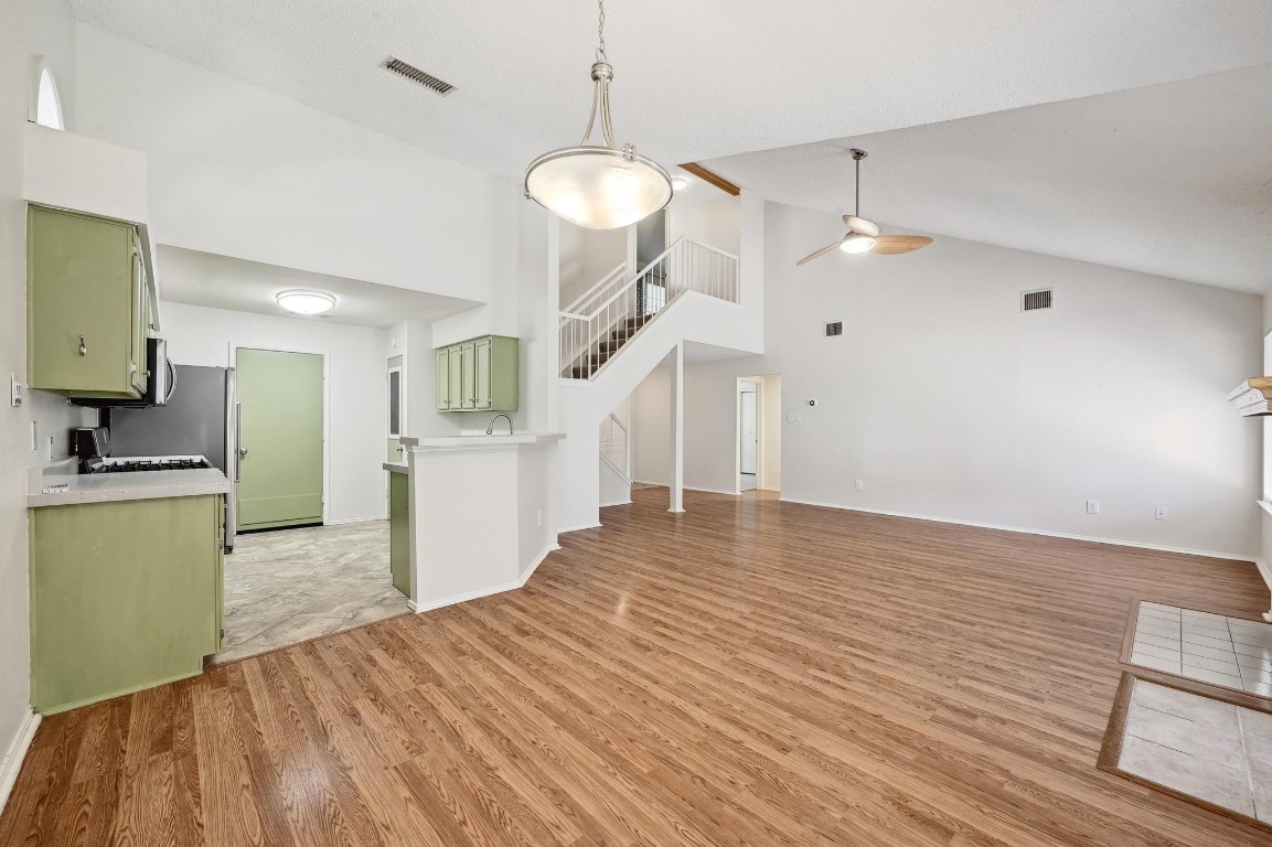 7201 Pine Bluffs Trail Austin, TX 78729 - Photo 7 of 25 a view of kitchen and hall with wooden floor