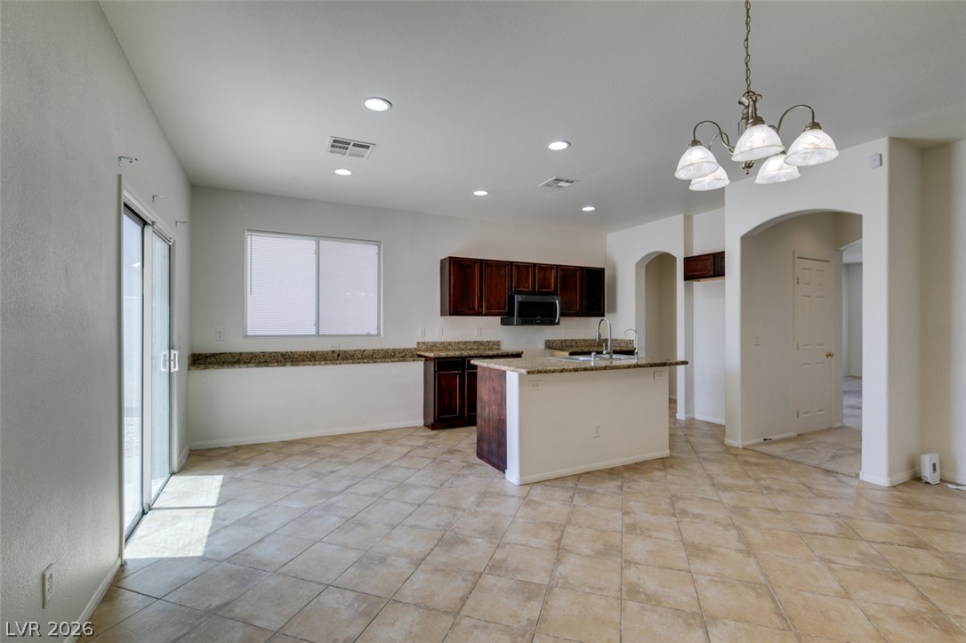 5150 Riverside Run Court North Las Vegas, NV 89081 - Photo 23 of 50 A versatile open-concept space featuring an inviting kitchen island and natural light.