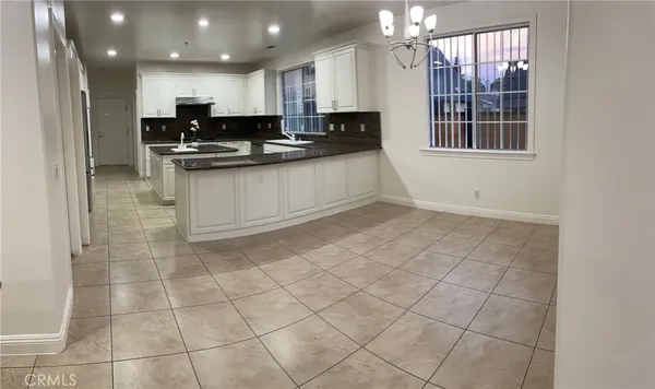 a kitchen with kitchen island granite countertop a stove a sink and a refrigerator