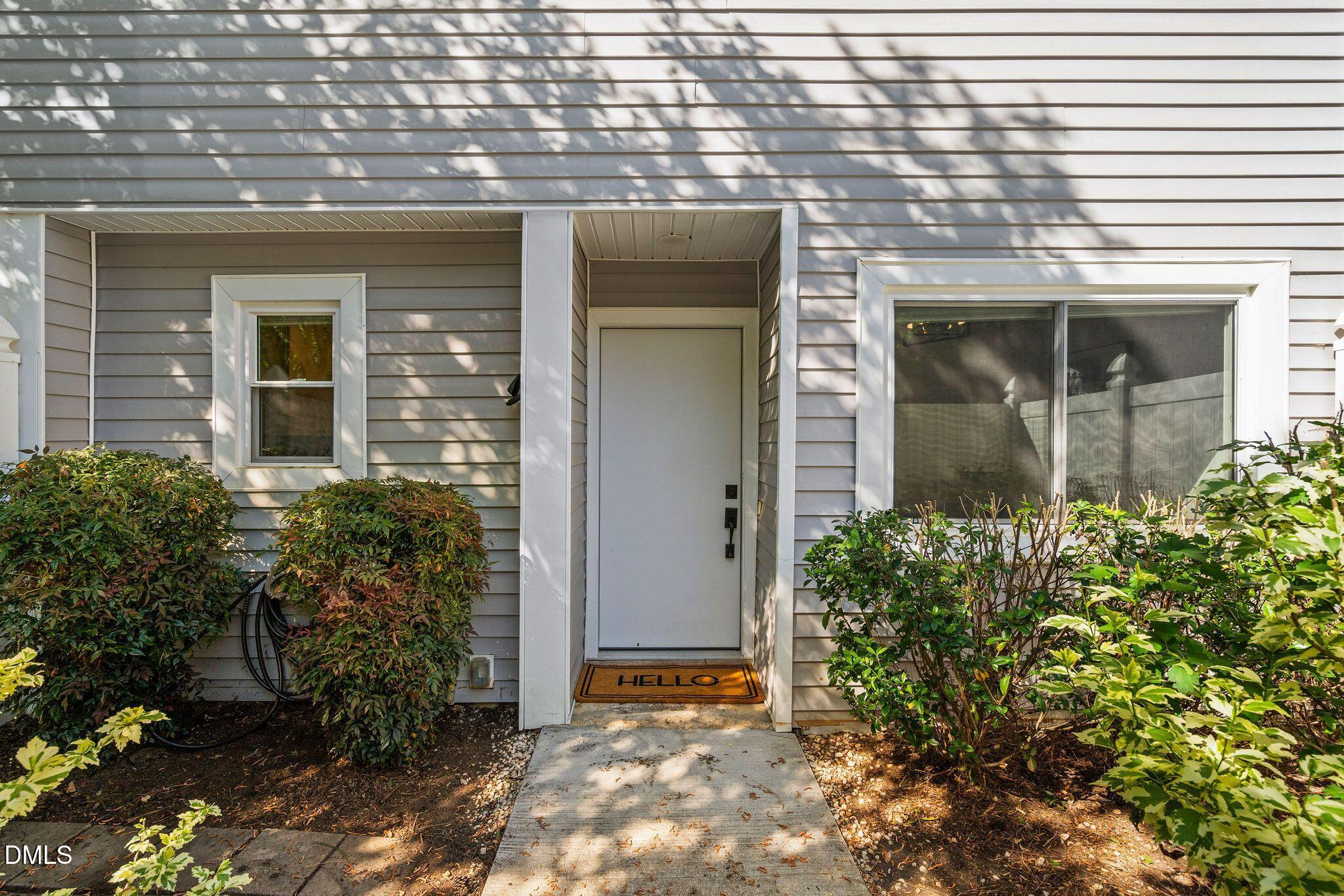 7149 Sandy Creek Drive Raleigh, NC 27615 - Photo 2 of 23 a front view of a house with garden