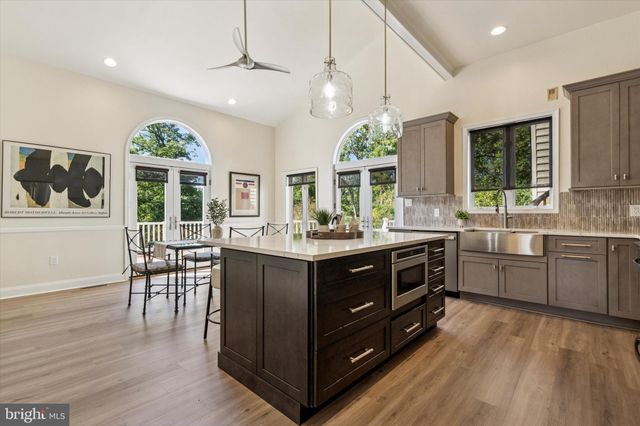 a kitchen with granite countertop a stove sink and cabinets