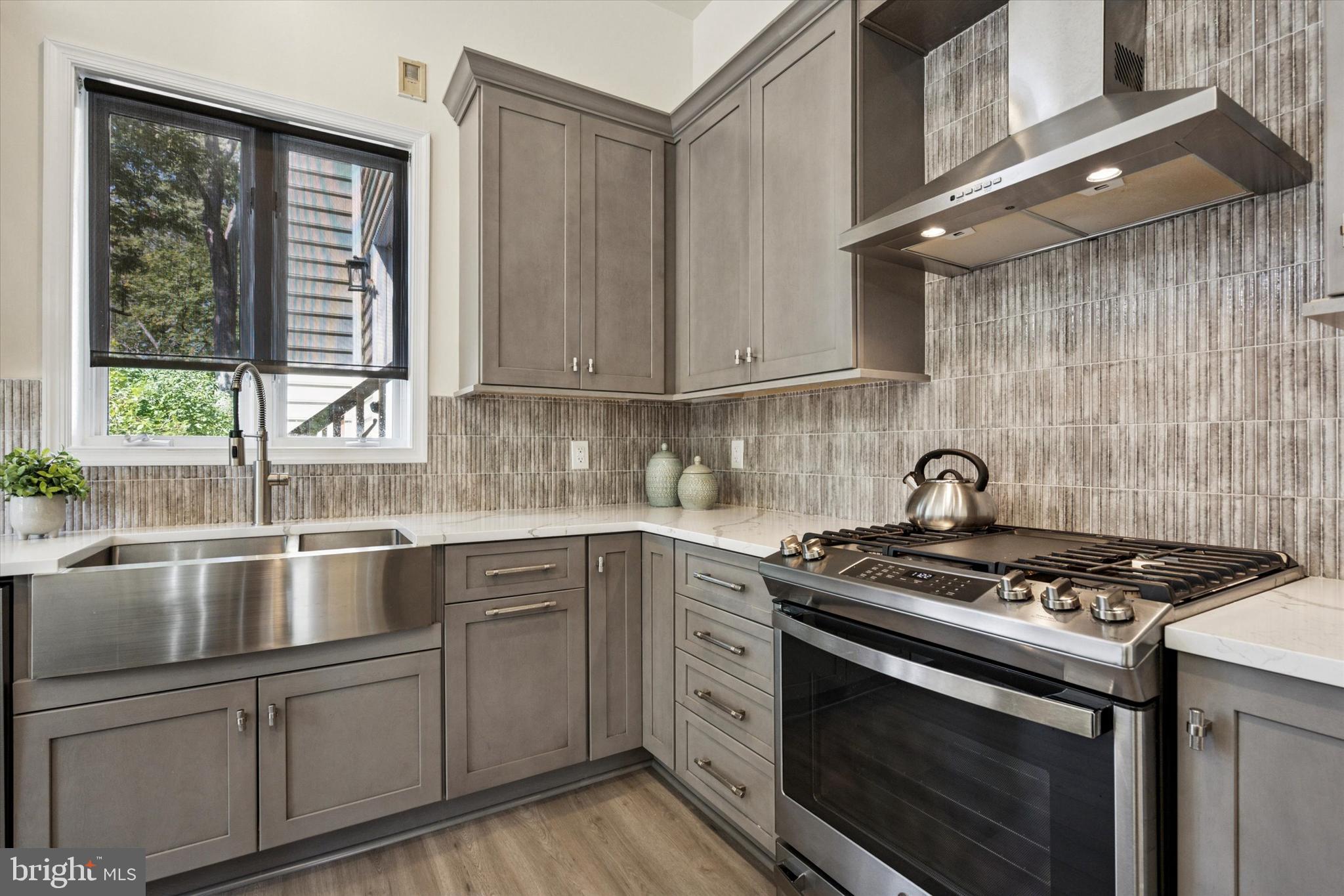241 Painter Road Media, PA 19063 - Photo 13 of 44 a kitchen with granite countertop a stove sink and cabinets