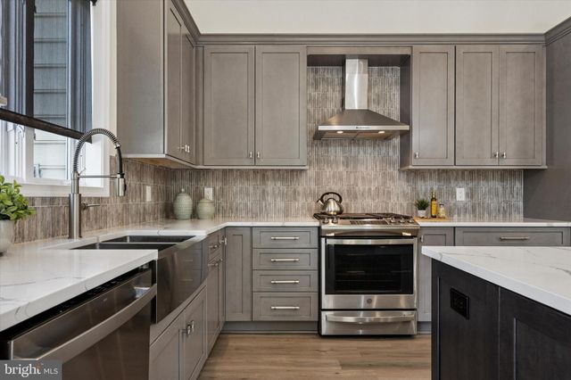 a kitchen with a sink stove and cabinets