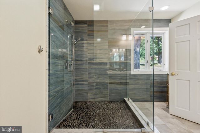 a living room with furniture a window and a potted plant