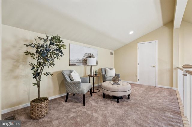 a spacious bedroom with a bed and a large window