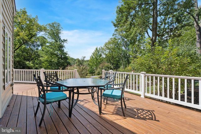 a view of balcony with wooden floor and fence