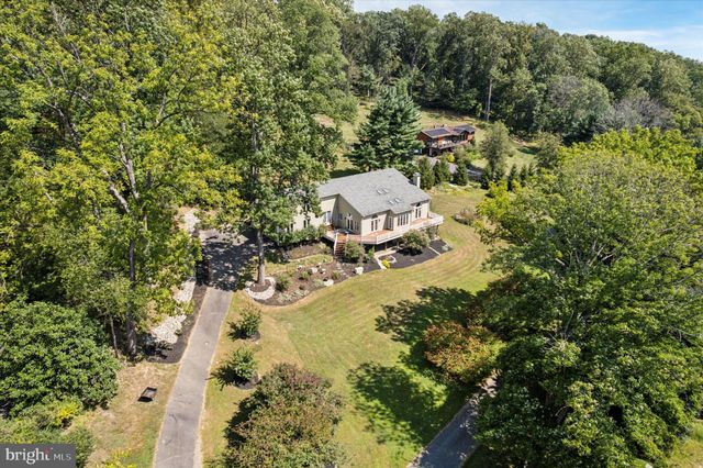 an aerial view of a house with a yard basket ball court and outdoor seating