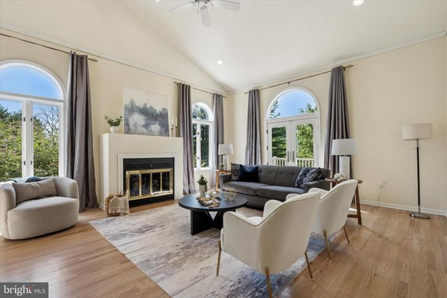 a living room with furniture a fireplace and a large window