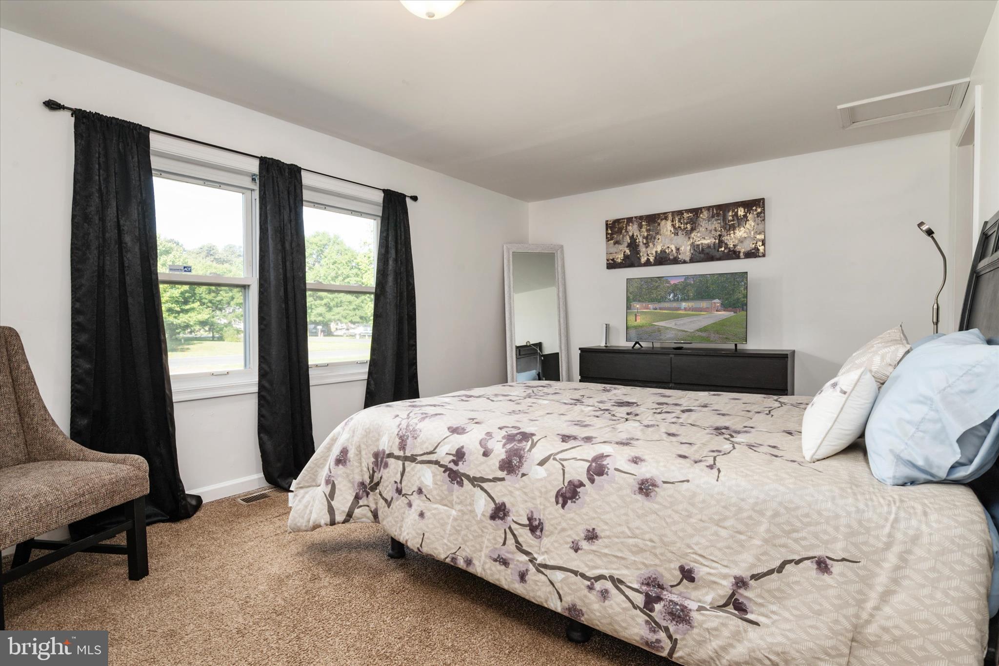 108 Wilson Road Grasonville, MD 21658 - Photo 16 of 38 a bedroom with a large bed and a window
