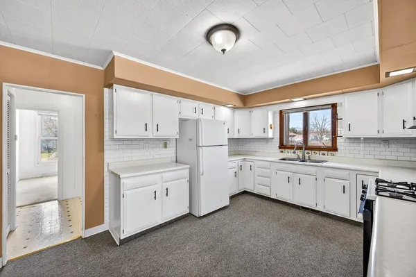 an empty room with wooden floor and fireplace