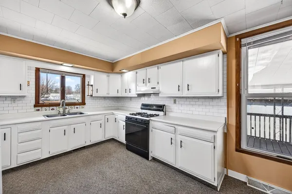 a view of a room with wooden floor and a window