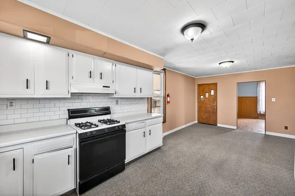 a view of a livingroom with wooden floor and a ceiling fan