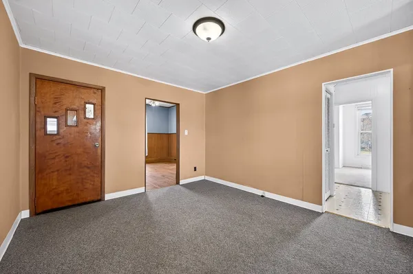 a view of an empty room and a window